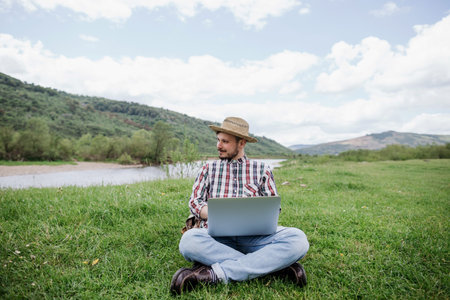 Always online. A young man works remotely on vacationの写真素材