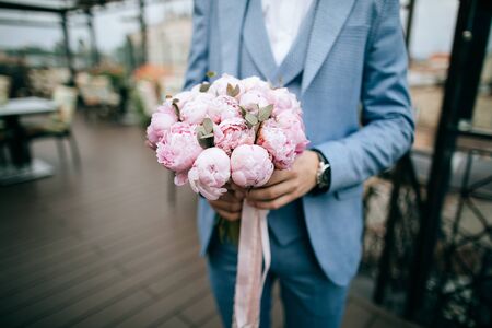Beautiful Wedding bouquet of pink tulips in hands of groom	
の写真素材