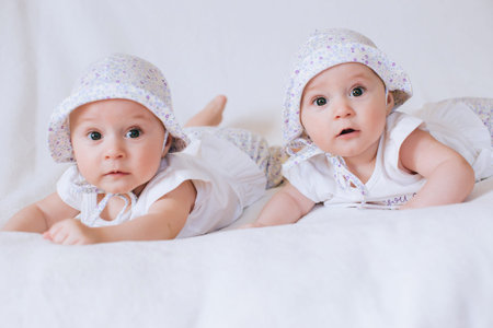 A mother holds her daughter in her arms and kisses her tenderly in the sun. The concept of...