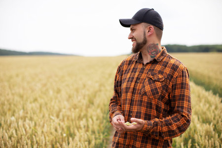 Happy farmer smiling on wheat field. Harvest time