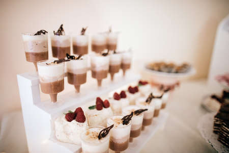 Wedding desserts cakes, candies on the dessert table at the wedding ceremonyの写真素材