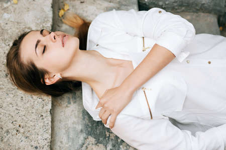 Outdoors portrait of beautiful young sensual woman with eyes closed. sleep conceptの写真素材