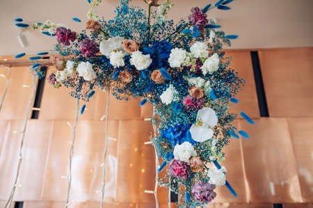 Beautiful decor of bouquets of hydrangeas, roses and orchids on the wedding arch in the restaurant. Wedding decorの写真素材