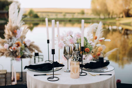 Decorated outdoor wedding table with flowers in boho styleの写真素材