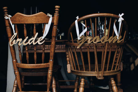 Vintage wooden chairs in a restaurant for the bride and groomの写真素材