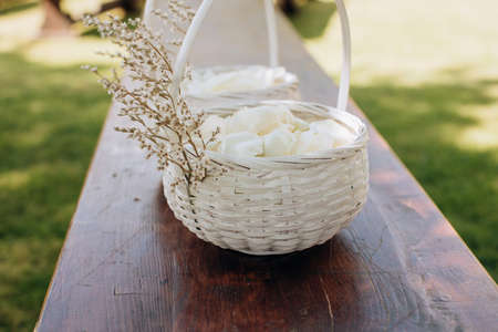 White rose petals in a basket for a wedding ceremonyの写真素材