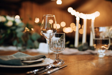 Beautiful wedding table setting with candles. empty wine glasses