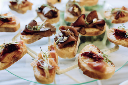 Catering banquet table with different food snacks and appetizers with sandwich