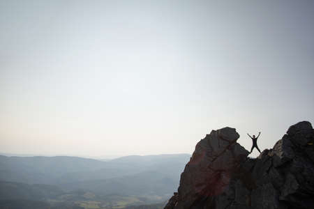 Silhouette of a man on top of a rock in the Carpathian mountains in Ukraine. The concept of freedomの写真素材