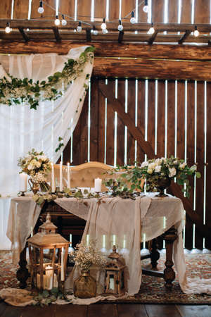 wedding reception. The wedding table is decorated with fresh flowers and candles in a rustic styleの写真素材