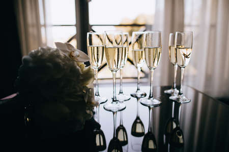Glasses of champagne in a restaurant on a dark background. celebrationの写真素材