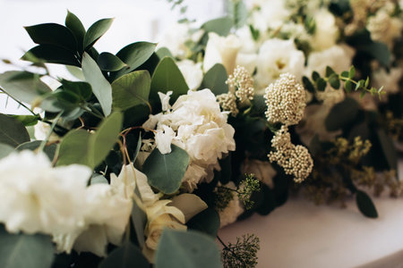 Arrangement of fresh flowers on the holiday table. Wedding decor in the restaurant