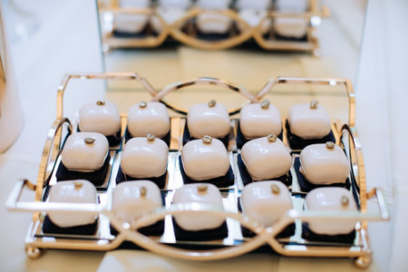 wedding desserts. Cakes in sweet icing on the table in a restaurantの写真素材