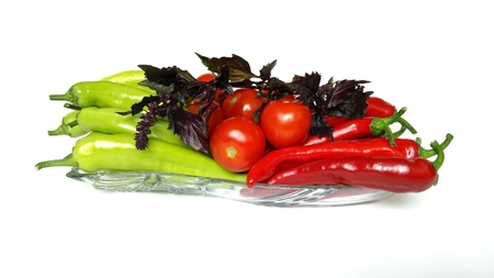 Some green and read peppers with tomatoes and bazilの写真素材