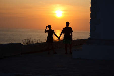 Lovers under lighthouse の写真素材