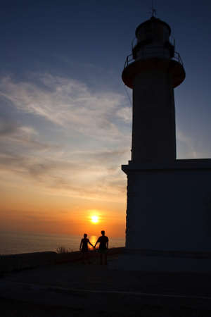 Lovers at sunset in the lighthouseの写真素材