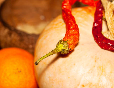 Red hot chili peppers on a pumpkinの写真素材