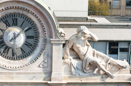 Statue next to yhe big clockの写真素材
