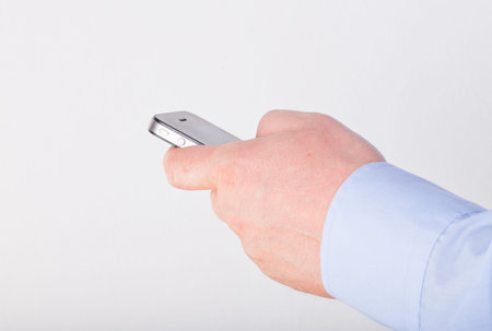 Hand holding a smart phone isolated on a white background
