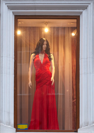 Female mannequin in a red dress in a shop windowのeditorial素材