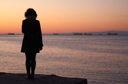 Silhouettes of a Woman that looking the sea, Triesteの写真素材