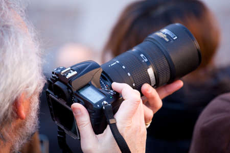 Photographer taking a photo with DSLR cameraの写真素材