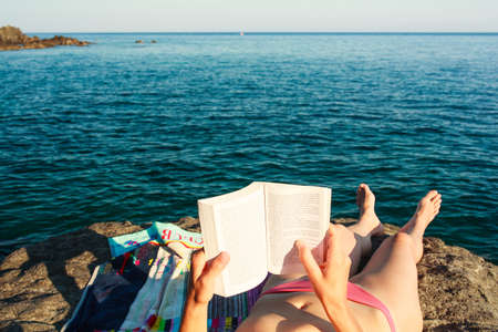 Girl Reading book in the beach, Pantelleriaの写真素材
