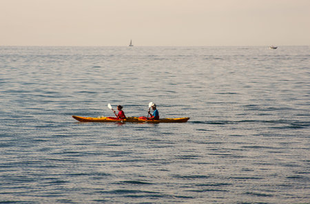 TRIESTE, ITALY - OCTOBER 13: Couple canoeing in the Trieste sea on SOctober 13, 2013