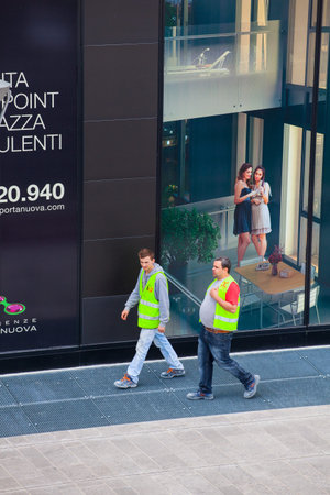 MILAN, ITALY -  MAY, 27: View of bricklayers walking in the street on May 27, 2014