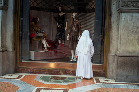 MILAN, ITALY - SEPTEMBER, 20: Nun looking the window shop in Milan on September 20, 2014のeditorial素材