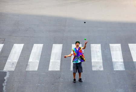 MILAN, ITALY -  MAY, 27: Juggler in the crossing road on May 27, 2014のeditorial素材