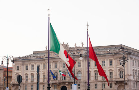 View of Italian and Trieste flags blowing in the windのeditorial素材