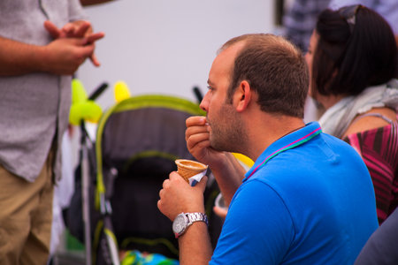 TRIESTE, ITALY - OCTOBER, 10: Man tasting delicious italian ice cream on October 10, 2014のeditorial素材
