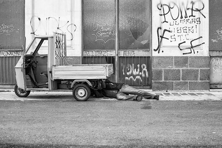 CATANIA, ITALY - DECEMBER, 15: Man under the hood of his three-wheeled on December 15, 2014のeditorial素材