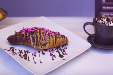 Close up of croissant with chocolate and candiesの写真素材