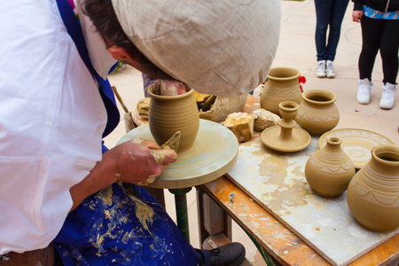 MILAN, ITALY - MAY, 20: Pottery maker uses a kick wheel to hand mold a pot from clay during the Expo, universal exposition on the theme Feeding the planet, Energy for life on May 20, 2015 in Milanのeditorial素材