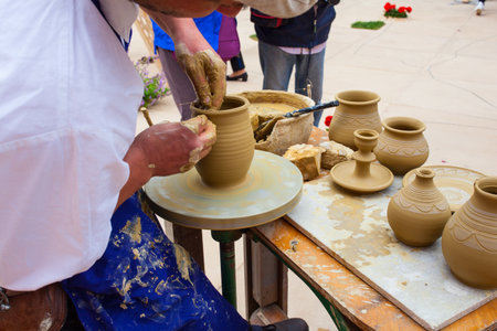 MILAN, ITALY - MAY, 20: Pottery maker uses a kick wheel to hand mold a pot from clay during the Expo, universal exposition on the theme Feeding the planet, Energy for life on May 20, 2015 in Milanのeditorial素材