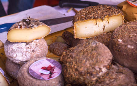 Italian cheeses covered in a layer of hay or cinderの写真素材