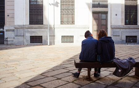 MILAN, ITALY - MARCH, 29: Couple of lovers sitting on a bench on March 29, 2015のeditorial素材