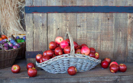 View of red apples inside a wicker basketの写真素材