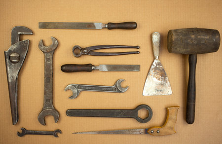 View of old set tools. Hammer, putty, knife, pliers, saw, file, wrench