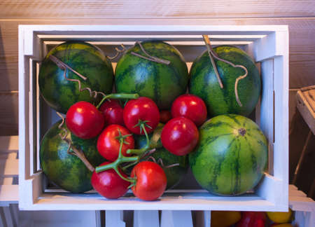 Watermelons and tomatoes inside the boxeの写真素材