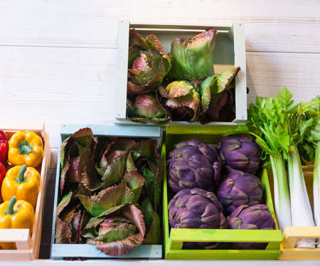 Artichokes, peppers, celery, radish in the boxesの写真素材