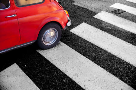 View of Cinquecento, retro Italian car on pedestrian crossingの写真素材
