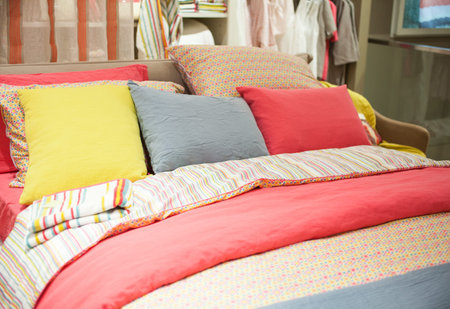 View of colorful pillows on bedroom