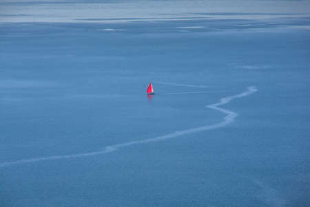 View of  solitary red sailboat on the adriatic seaの写真素材