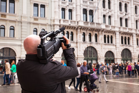 TRIESTE, ITALY - MAY, 14: Cameraman take a movie in the street on May 14, 2016のeditorial素材