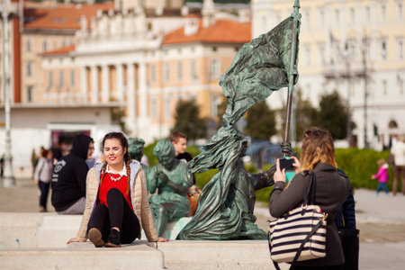 TRIESTE, ITALY - APRIL, 28: Young woman taking a photo of her friend on April 28, 2016のeditorial素材