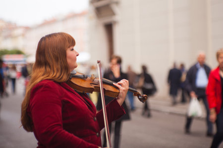 TRIESTE, ITALY - MAY, 14: Female violinist playing in the street on May 14, 2016のeditorial素材