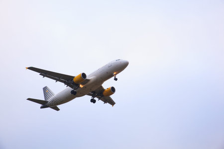 SANTIAGO, SPAIN - AUGUST, 16: Airplane flying on gray sky on August 16, 2016